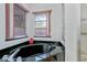 Bathroom featuring a corner tub, pink window trim, and walk-in shower at 1169 Presque Isle Dr, Port Charlotte, FL 33952