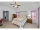 Bright bedroom with ceiling fan, neutral carpet and a large window at 1169 Presque Isle Dr, Port Charlotte, FL 33952