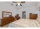 Spacious bedroom features plush carpet, a ceiling fan, and neutral-colored walls at 1169 Presque Isle Dr, Port Charlotte, FL 33952