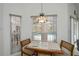 Cozy breakfast nook area with tile table and chairs, views of the screened-in pool area at 1169 Presque Isle Dr, Port Charlotte, FL 33952