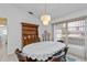 The dining room features a wooden hutch, large table and window with exterior views at 1169 Presque Isle Dr, Port Charlotte, FL 33952