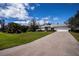 Well-maintained single-story home featuring a long driveway and manicured lawn, showcasing curb appeal at 1169 Presque Isle Dr, Port Charlotte, FL 33952