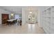 Bright foyer flowing into a dining area with tile flooring, mirrored walls and built-in shelving at 1169 Presque Isle Dr, Port Charlotte, FL 33952