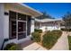 Screened-in entryway leading to a home with neat landscaping at 1169 Presque Isle Dr, Port Charlotte, FL 33952