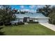 Beautiful one-story home with a well-manicured lawn and a two-car garage at 1169 Presque Isle Dr, Port Charlotte, FL 33952