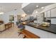 Open kitchen with barstool seating, white cabinetry, and tile flooring at 1169 Presque Isle Dr, Port Charlotte, FL 33952