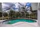 Enclosed pool with clear turquoise water under a white frame and screen enclosure at 1169 Presque Isle Dr, Port Charlotte, FL 33952