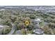 Scenic aerial view of home nestled among lush trees in a tranquil neighborhood at 1350 Old Oak Trl, Port Charlotte, FL 33948