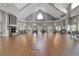 Spacious ballroom features a stone fireplace, hardwood floors, and ample seating at 1350 Old Oak Trl, Port Charlotte, FL 33948