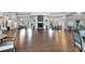 Spacious ballroom features a stone fireplace, hardwood floors, and ample seating at 1350 Old Oak Trl, Port Charlotte, FL 33948