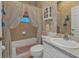 A classic bathroom with tiled tub and walls, adorned with floral wallpaper and vintage-style curtains at 1350 Old Oak Trl, Port Charlotte, FL 33948