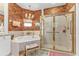 Bathroom featuring a gold-trimmed shower, garden tub, and rust-colored walls that give a touch of elegance at 1350 Old Oak Trl, Port Charlotte, FL 33948