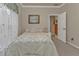 Inviting bedroom featuring a patterned comforter, with a bedside table and soft natural light creating a comfortable space at 1350 Old Oak Trl, Port Charlotte, FL 33948