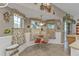 Inviting breakfast nook with a glass table, wainscoting, and cheerful floral decor at 1350 Old Oak Trl, Port Charlotte, FL 33948