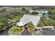 Exterior of community clubhouse with parking, lush landscaping and easy access at 1350 Old Oak Trl, Port Charlotte, FL 33948