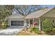 Charming single-story home with a well-maintained lawn, screened porch, and a two-car garage at 1350 Old Oak Trl, Port Charlotte, FL 33948