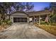 Charming single-story home with a well-maintained lawn, screened porch, and a two-car garage at 1350 Old Oak Trl, Port Charlotte, FL 33948