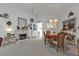 Elegant living room with a fireplace, dining area, and bright natural light at 1350 Old Oak Trl, Port Charlotte, FL 33948