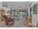 Spacious living room with comfortable seating, a ceiling fan, and a sliding glass door to the outside at 1350 Old Oak Trl, Port Charlotte, FL 33948