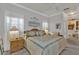 Well-lit bedroom with a decorative bed, carpeted floor, and scenic wall art at 1350 Old Oak Trl, Port Charlotte, FL 33948