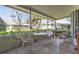 Enjoy the outdoors on this charming tiled patio with comfortable seating and scenic views of lush greenery at 1350 Old Oak Trl, Port Charlotte, FL 33948
