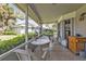 Relax on this tiled patio featuring comfortable seating and scenic views of the surrounding greenery and neighboring homes at 1350 Old Oak Trl, Port Charlotte, FL 33948