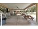 Covered picnic area with tables and chairs, great for outdoor gatherings in a beautifully landscaped setting at 1350 Old Oak Trl, Port Charlotte, FL 33948