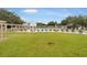 Expansive community pool surrounded by lush green lawns and seating areas for residents to relax and socialize at 1350 Old Oak Trl, Port Charlotte, FL 33948