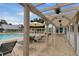 Relaxing poolside area with comfortable seating, a great place to unwind and enjoy the outdoors at 1350 Old Oak Trl, Port Charlotte, FL 33948