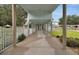 Covered walkway leads to community building, set amidst landscaped grounds and creating an inviting outdoor space at 1350 Old Oak Trl, Port Charlotte, FL 33948