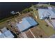 An aerial view of a canal-front home with private boat dock and lush landscaping at 137 Poinsettia Ne Cir, Port Charlotte, FL 33952
