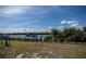 Fenced backyard overlooking a canal with a private dock, perfect for boating enthusiasts at 137 Poinsettia Ne Cir, Port Charlotte, FL 33952