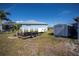 Boat trailer parked in the backyard with storage shed, suitable for waterfront living at 137 Poinsettia Ne Cir, Port Charlotte, FL 33952