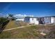 Spacious backyard with partial fencing, offering a view of the neighboring home at 137 Poinsettia Ne Cir, Port Charlotte, FL 33952
