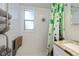 Bathroom featuring a decorative shower curtain, a vanity with a marble countertop, and towel rack for storage at 137 Poinsettia Ne Cir, Port Charlotte, FL 33952