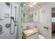 Bathroom featuring a showerhead, a vanity with a marble countertop, and a mirrored medicine cabinet at 137 Poinsettia Ne Cir, Port Charlotte, FL 33952
