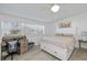 Bright bedroom with white furniture, ceiling fan, and light wood-look flooring at 137 Poinsettia Ne Cir, Port Charlotte, FL 33952