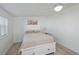Bedroom features white furniture, ceiling fan, and light wood-look flooring at 137 Poinsettia Ne Cir, Port Charlotte, FL 33952