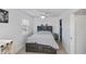 Bedroom features neutral decor, a ceiling fan, and light wood-look flooring at 137 Poinsettia Ne Cir, Port Charlotte, FL 33952