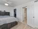 Bedroom boasts wood-look floors and closet that leads into the bathroom at 137 Poinsettia Ne Cir, Port Charlotte, FL 33952
