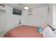 Inviting bedroom with a soft pink comforter, a wall-mounted TV, and a cozy ambiance at 137 Poinsettia Ne Cir, Port Charlotte, FL 33952