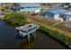 Canal-front home featuring a private boat lift, ideal for boating enthusiasts at 137 Poinsettia Ne Cir, Port Charlotte, FL 33952