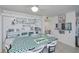 Dining area with white furniture, a large table with a green tablecloth, and a view into the kitchen at 137 Poinsettia Ne Cir, Port Charlotte, FL 33952