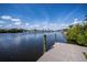 Private dock with a picturesque view of the calm waterway and lush green surroundings at 137 Poinsettia Ne Cir, Port Charlotte, FL 33952