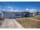 Charming single-story home with a well-maintained lawn and a convenient attached garage at 137 Poinsettia Ne Cir, Port Charlotte, FL 33952