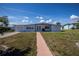 Single-story home with a simple walkway and well-maintained lawn, a classic look at 137 Poinsettia Ne Cir, Port Charlotte, FL 33952