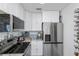 Bright kitchen with stainless appliances, white cabinetry, and granite countertops at 137 Poinsettia Ne Cir, Port Charlotte, FL 33952
