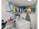 Well-stocked laundry room with a washer, shelves stocked with supplies, and an ironing board for convenience at 137 Poinsettia Ne Cir, Port Charlotte, FL 33952