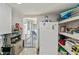 Bright laundry area with white cabinets, large fridge, and convenient access to the outdoors at 137 Poinsettia Ne Cir, Port Charlotte, FL 33952