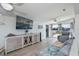Bright living room with a large TV, modern furniture and sliding doors to the patio area at 137 Poinsettia Ne Cir, Port Charlotte, FL 33952
